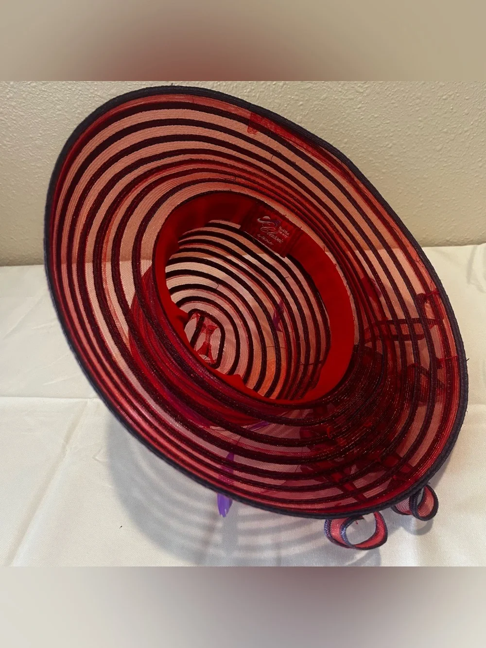 Elegant Red Wide-Brim Dress Hat with Purple Feather Trim